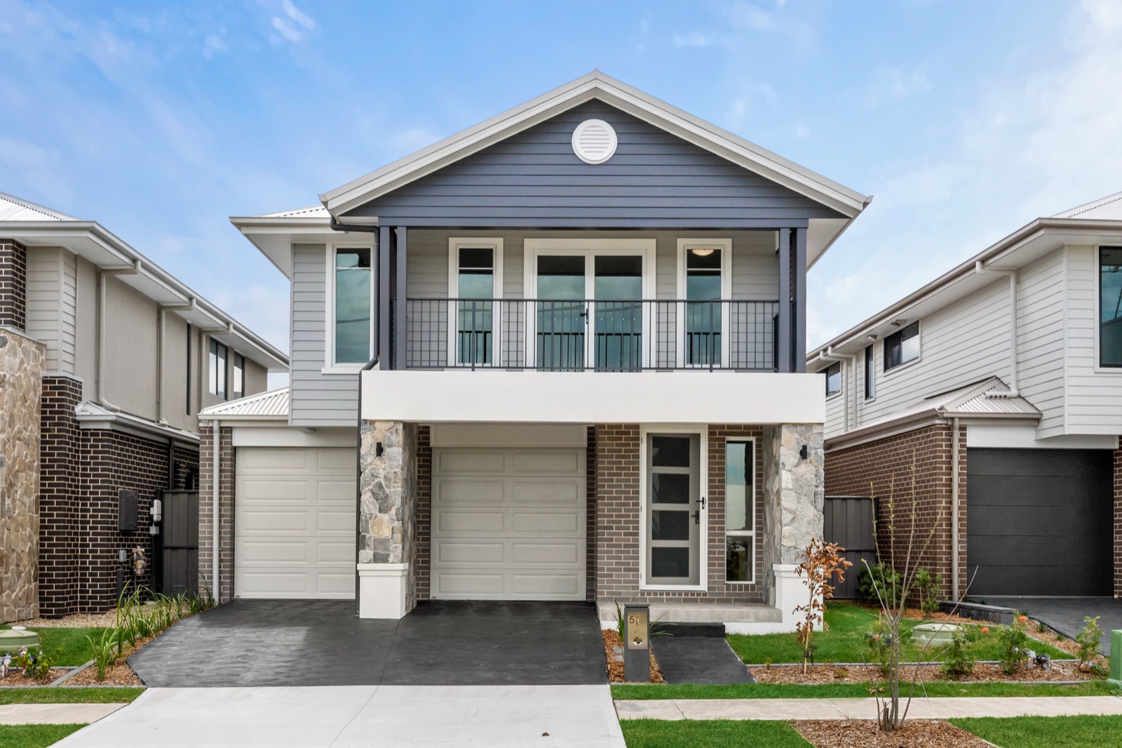 Hamptons-style two-storey home with a feature gable and balcony
