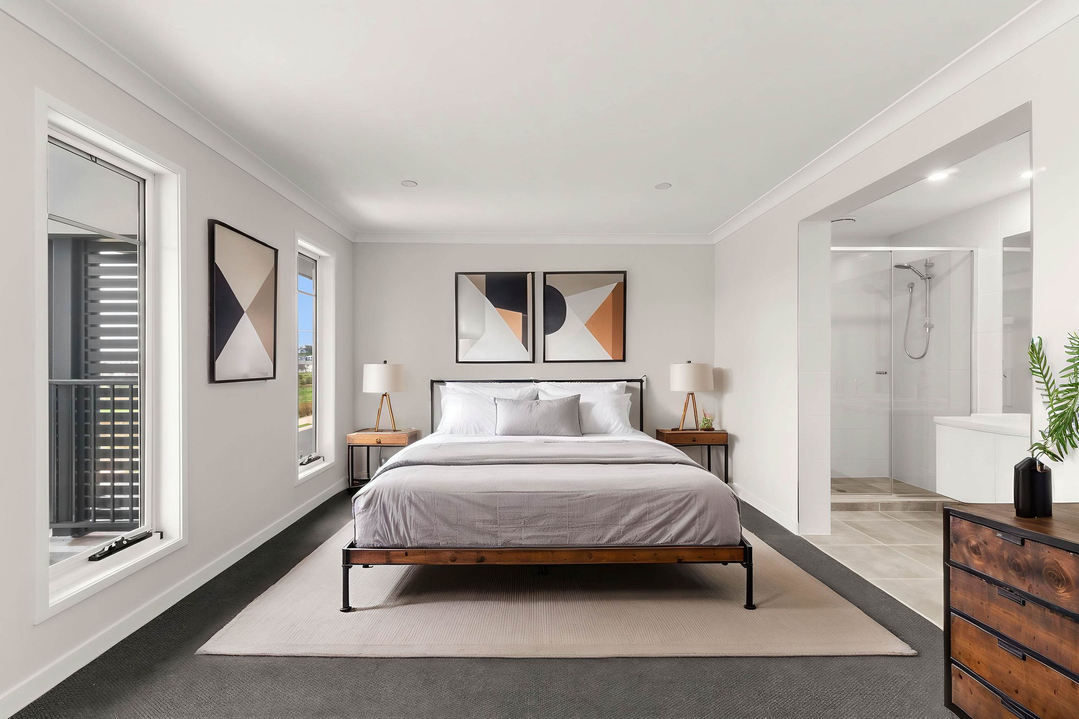 Interior photograph of a master bedroom with natural light and styled furnishings