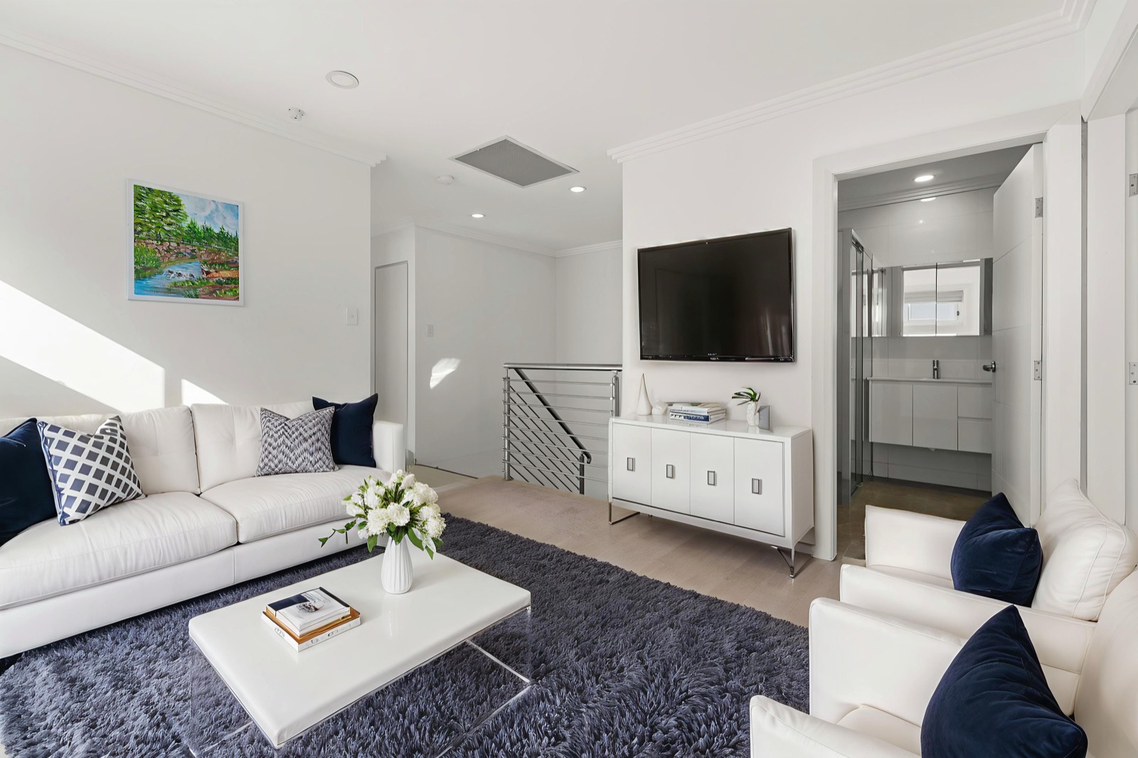 Open-plan upstairs living space filled with natural light